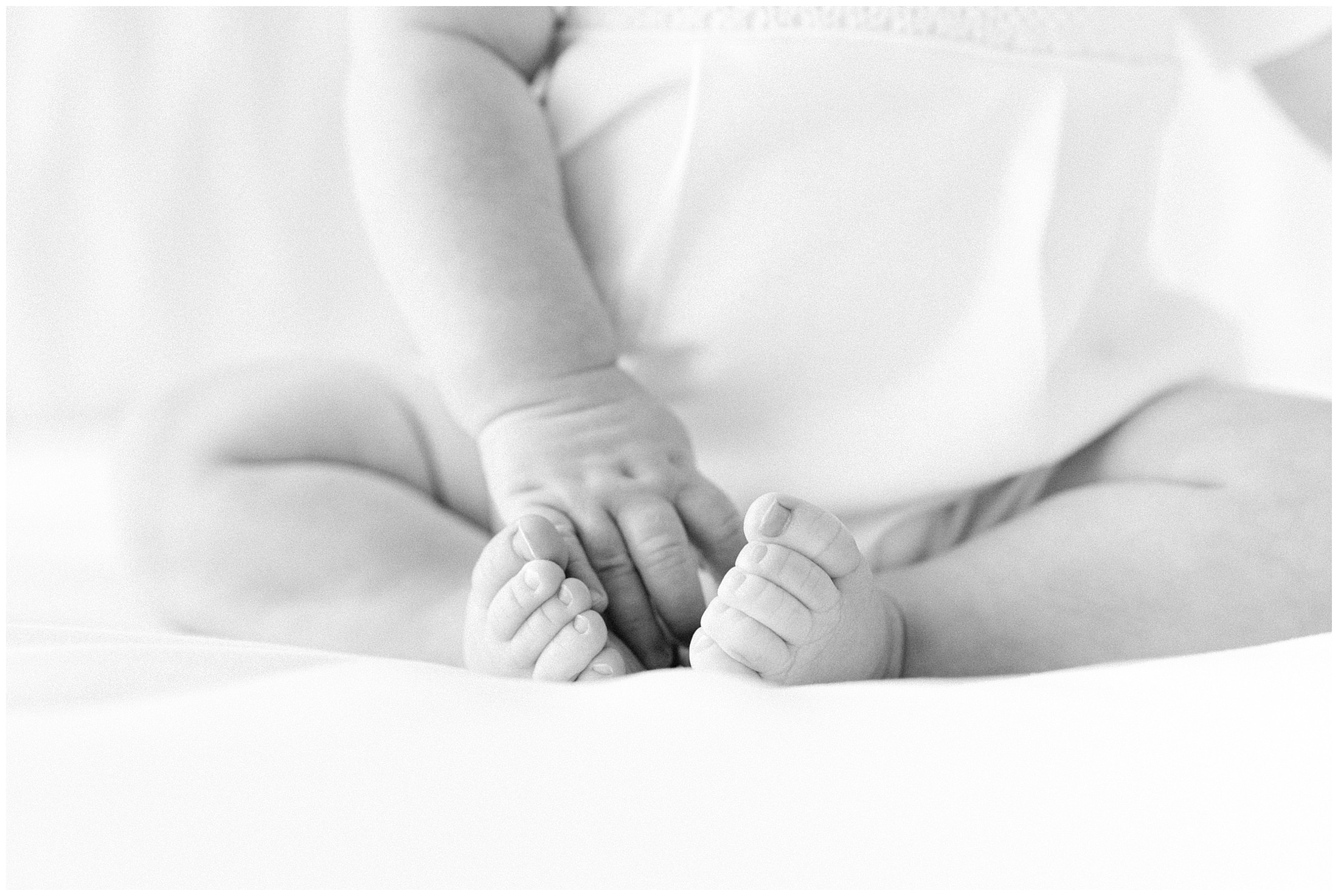 Artistic photo of a baby's hand and two feet during a sitter session by Atlanta Georgia photographer Lindsey Powell.