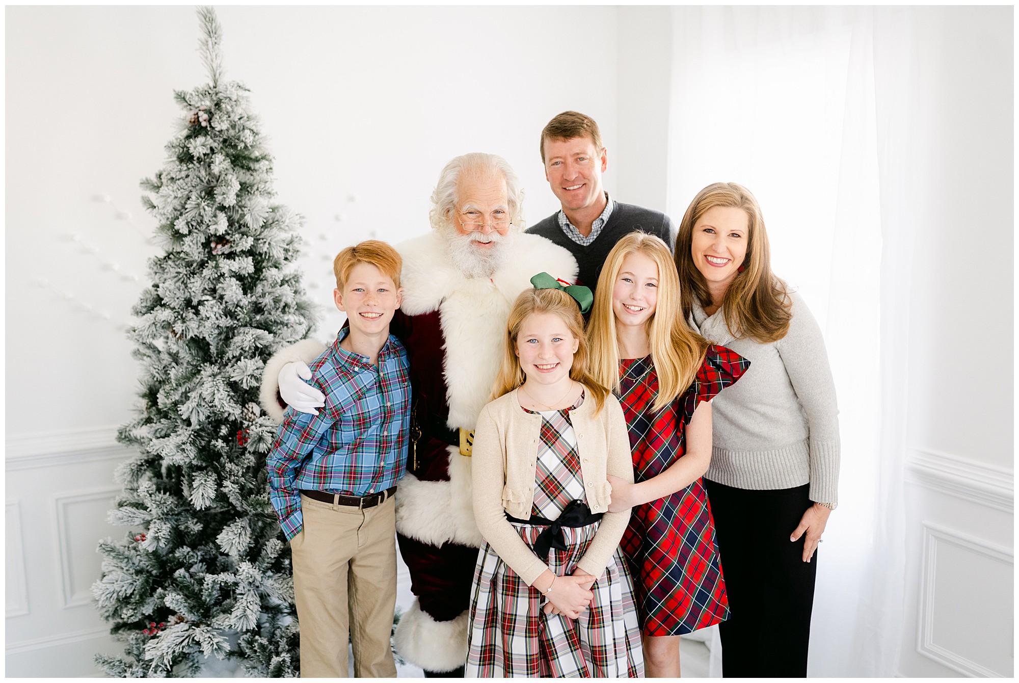 A family of 5 poses with Santa during an Atlanta Santa photo session.